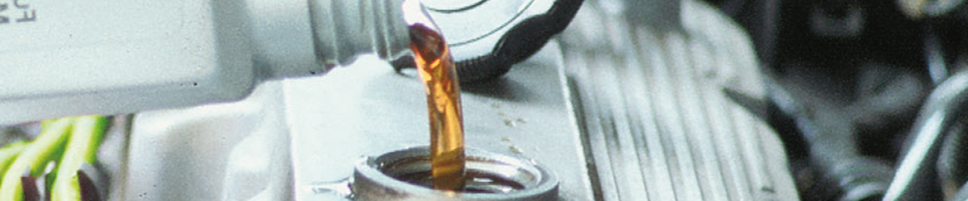 Engine oil being poured into a car engine